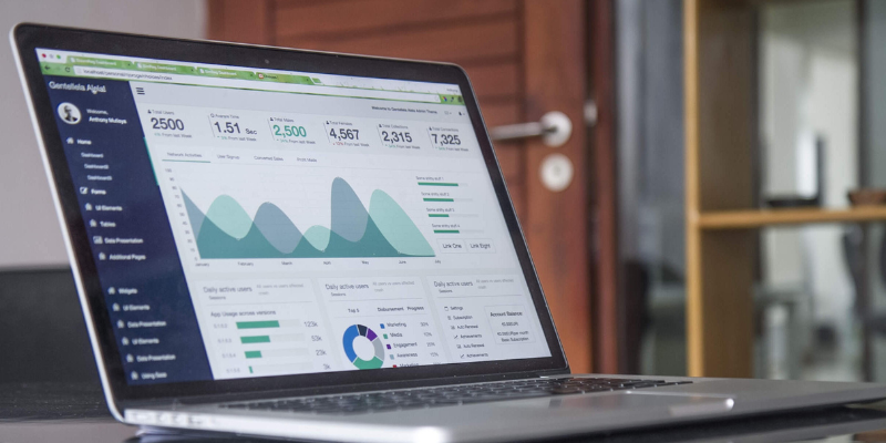 A laptop sitting on a table that is open to analytical data